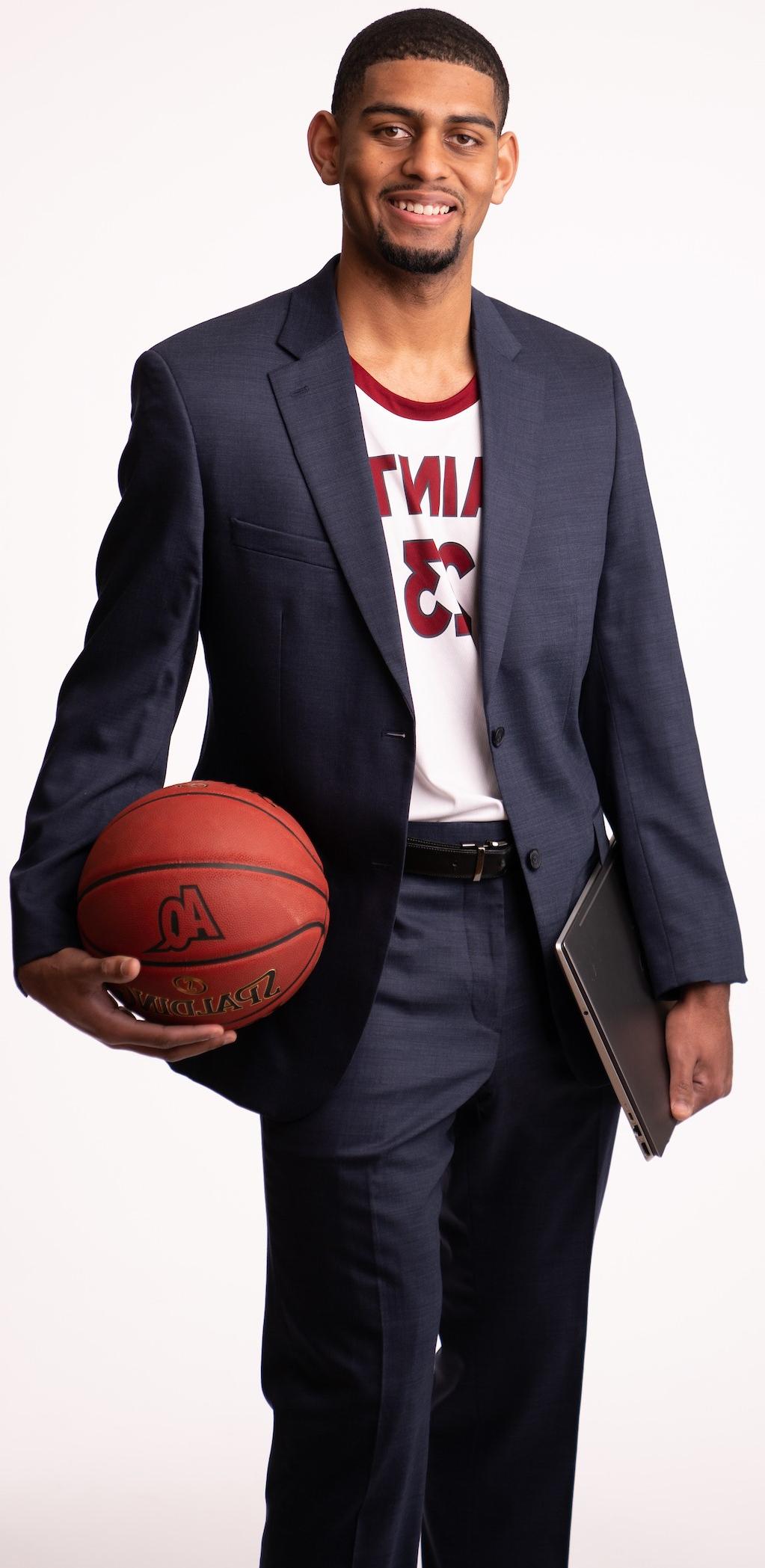 Justin Lary holding a basketball